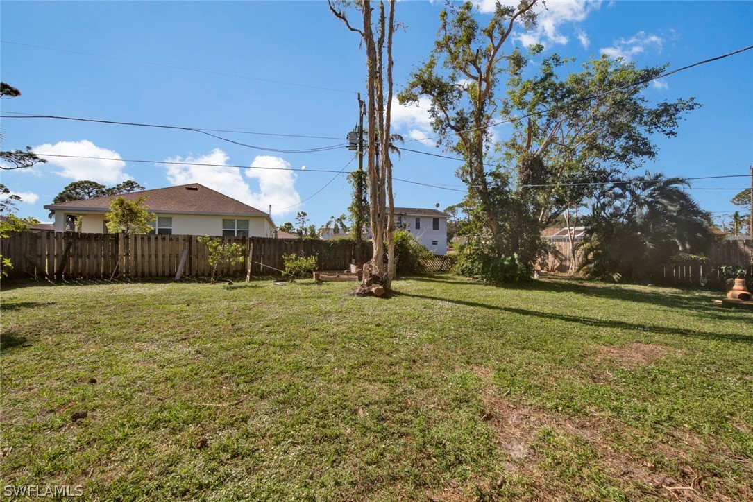 18442 Sunflower Road Fort Myers, FL 33967 - Photo 4 of 26 a backyard of a house with lots of green space