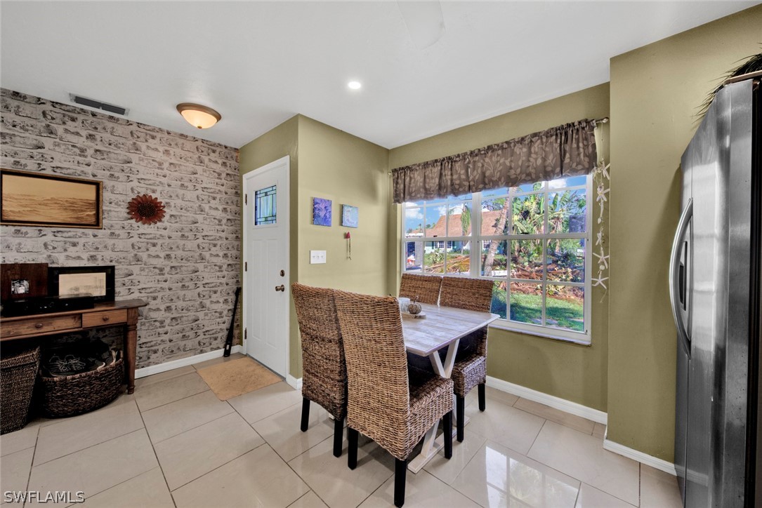 18442 Sunflower Road Fort Myers, FL 33967 - Photo 5 of 26 a dining room with furniture and a fireplace