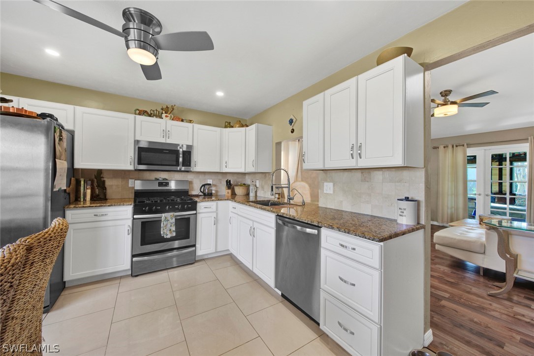18442 Sunflower Road Fort Myers, FL 33967 - Photo 7 of 26 a kitchen with cabinets and stainless steel appliances