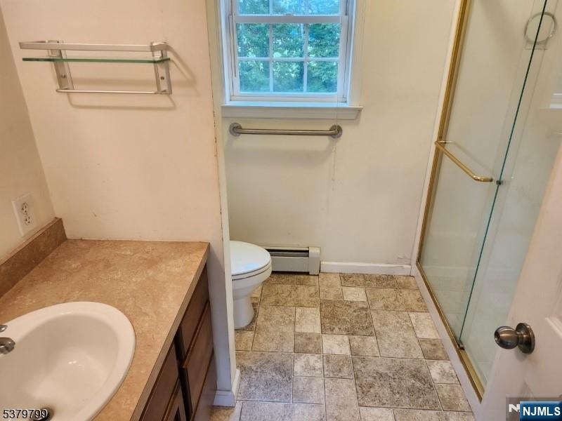 128 Big Piece Road Fairfield, NJ 07004 - Photo 13 of 26 a bath room with a sink and a toilet