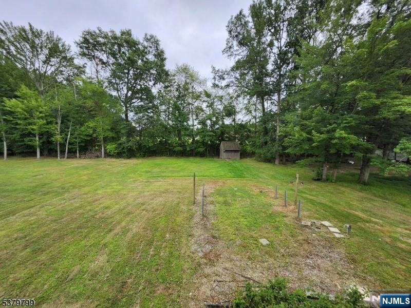 128 Big Piece Road Fairfield, NJ 07004 - Photo 22 of 26 a view of a grassy field with trees in the background