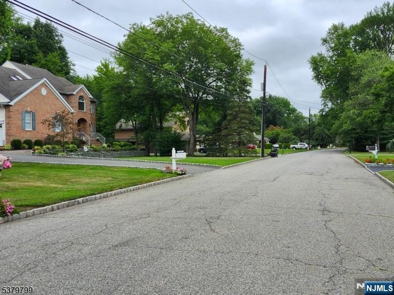 128 Big Piece Road Fairfield, NJ 07004 - Photo 24 of 26 a view of a house with a big yard and large trees
