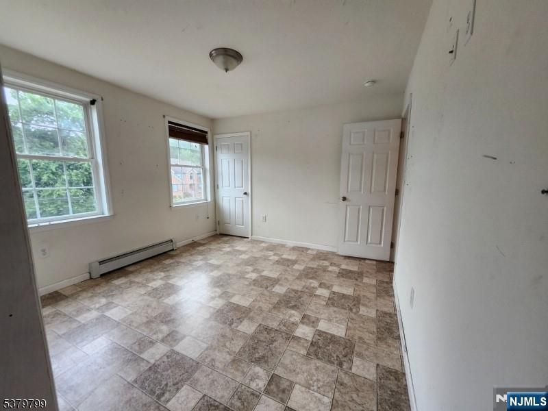 128 Big Piece Road Fairfield, NJ 07004 - Photo 3 of 26 a view of an empty room with a window