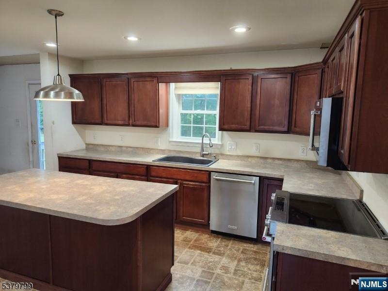 128 Big Piece Road Fairfield, NJ 07004 - Photo 5 of 26 a kitchen with stainless steel appliances granite countertop sink stove top oven and cabinets
