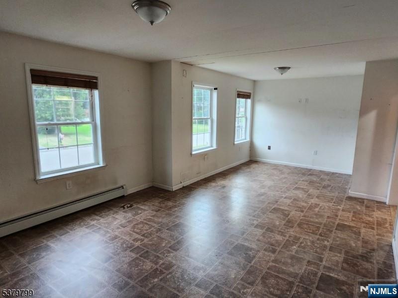 128 Big Piece Road Fairfield, NJ 07004 - Photo 6 of 26 an empty room with windows