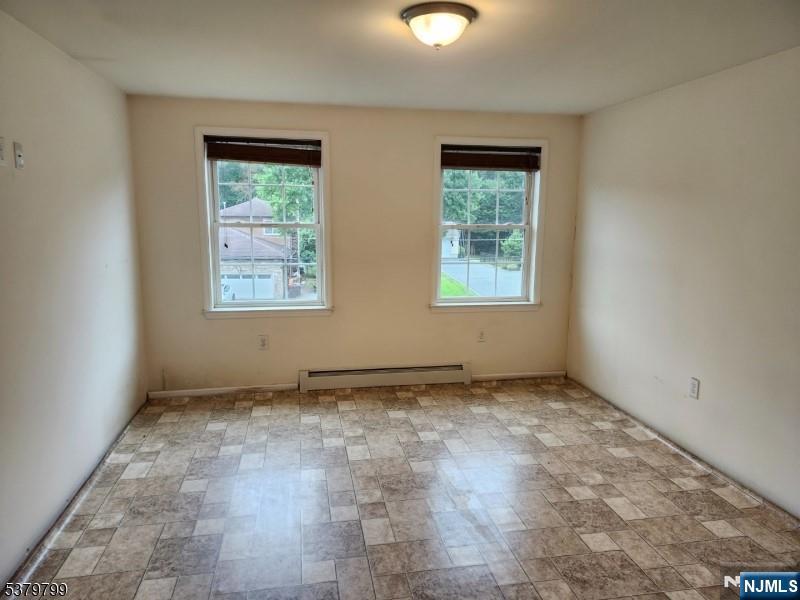 128 Big Piece Road Fairfield, NJ 07004 - Photo 8 of 26 an empty room with windows