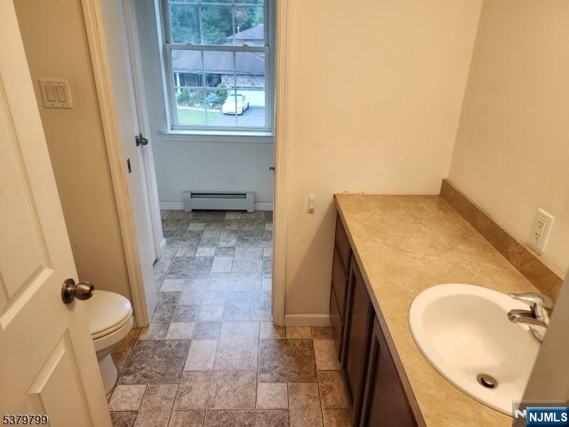 128 Big Piece Road Fairfield, NJ 07004 - Photo 9 of 26 a bathroom with a sink and a mirror