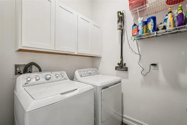 a view of walk in closet with clothes