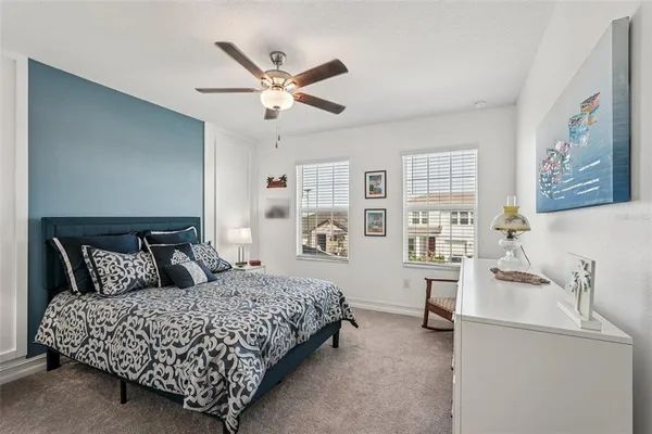a bedroom with a bed and a ceiling fan