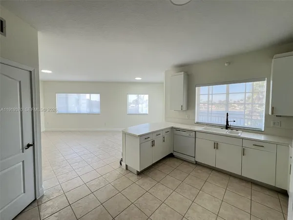 a view of a kitchen with white cabinets
