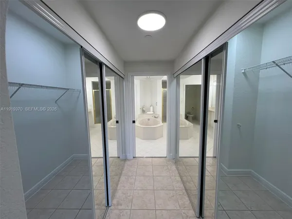 a large bathroom with a double vanity sink mirror and bathtub