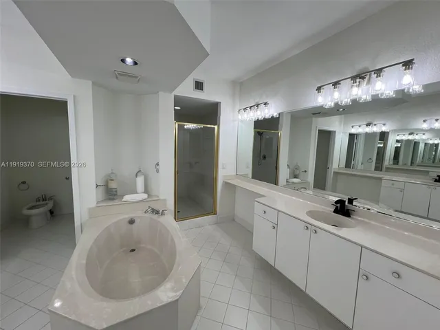 a spacious bathroom with a double vanity sink and a mirror