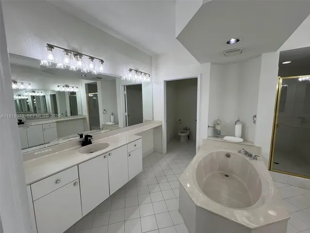 a spacious bathroom with a granite countertop sink and a mirror