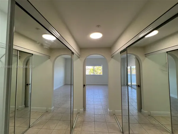 a view of a big room with closet and windows