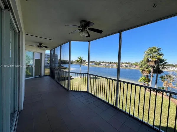 a kitchen with a sink a stove a refrigerator and white cabinets