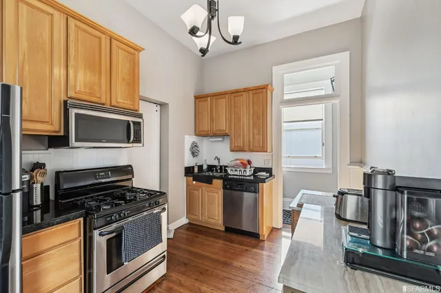 a view of a dining room with furniture and a potted plant