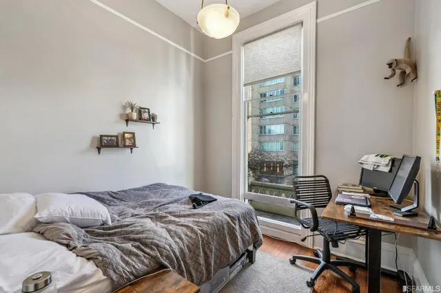 a living room with furniture kitchen view and a potted plant