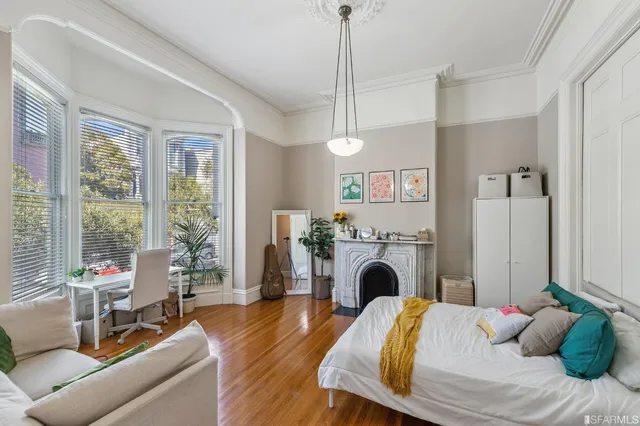 a bedroom with bed and a fireplace