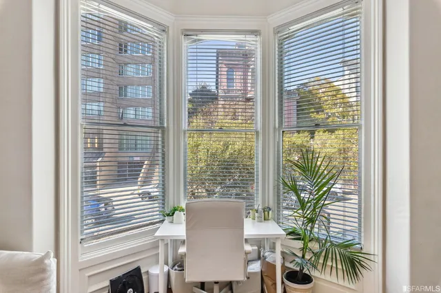 a bedroom with a bed couch and a window