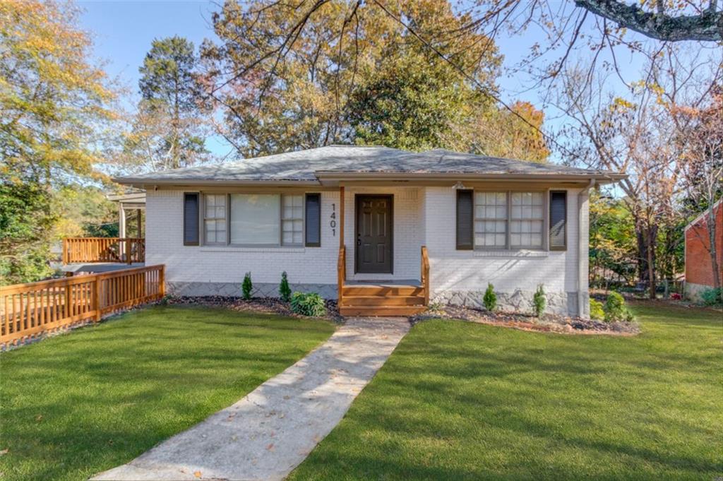 a front view of house with yard outdoor seating and green space