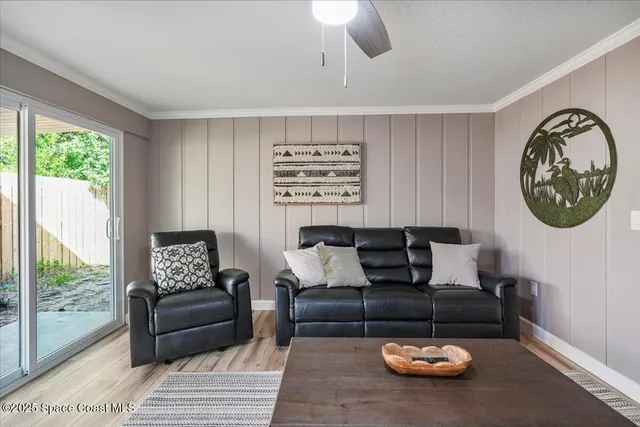 a bedroom with a bed chandelier and a window