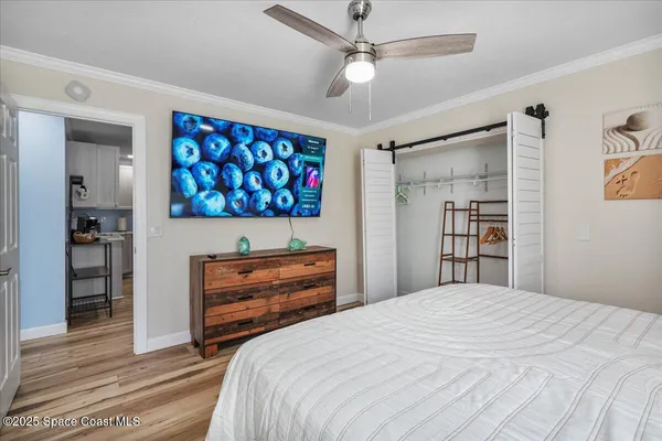 a kitchen with stainless steel appliances granite countertop a stove top oven a sink dishwasher a dining table and chairs with wooden floor