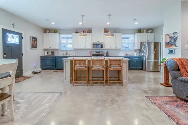 a bathroom with a granite countertop toilet a sink and a mirror