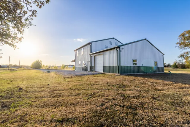 a living room with stainless steel appliances a dining table and a dining table with kitchen view