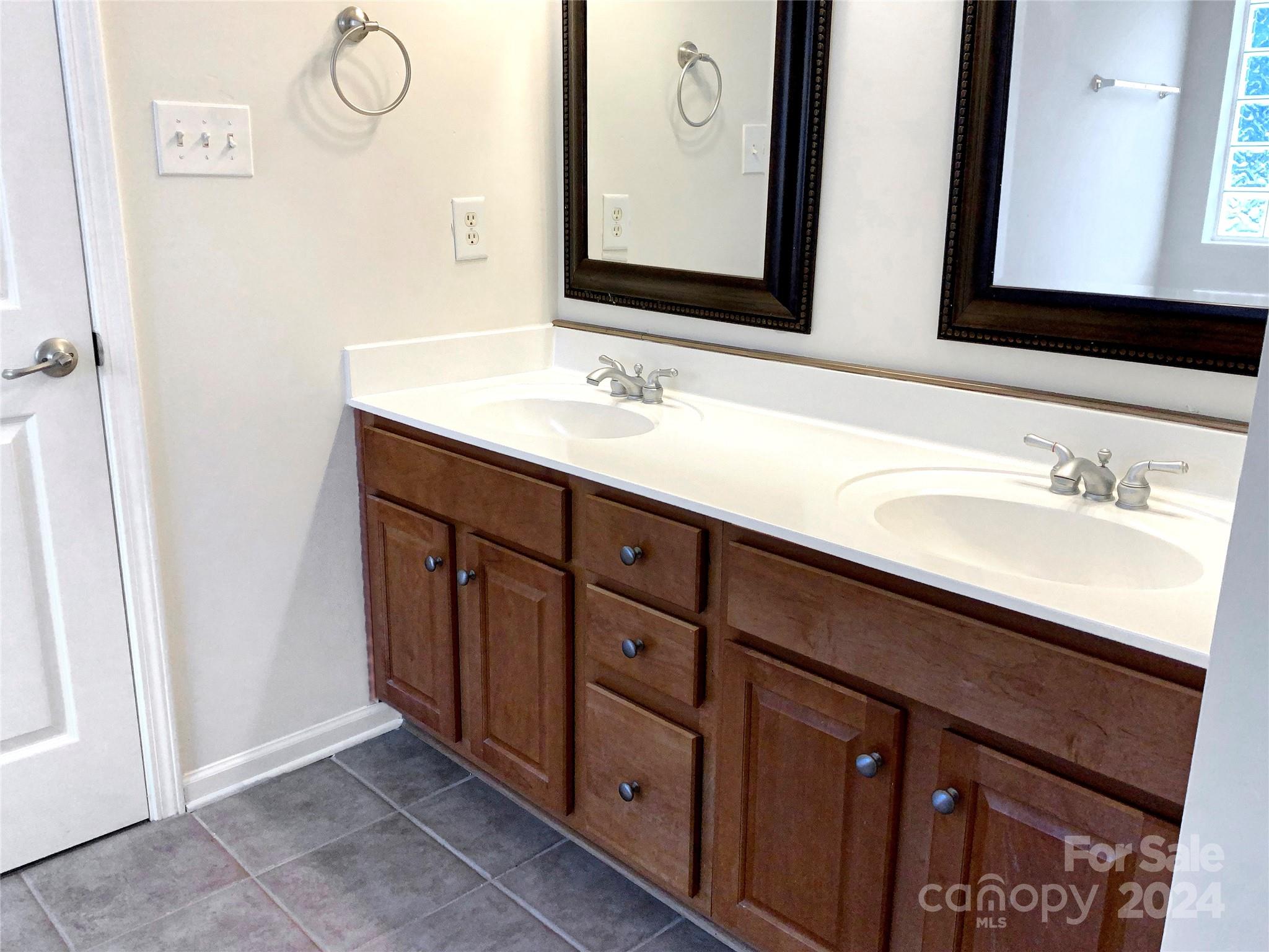 13413 Meadowmere Road Huntersville, NC 28078 - Photo 14 of 22 a bathroom with a double vanity sink and a mirror