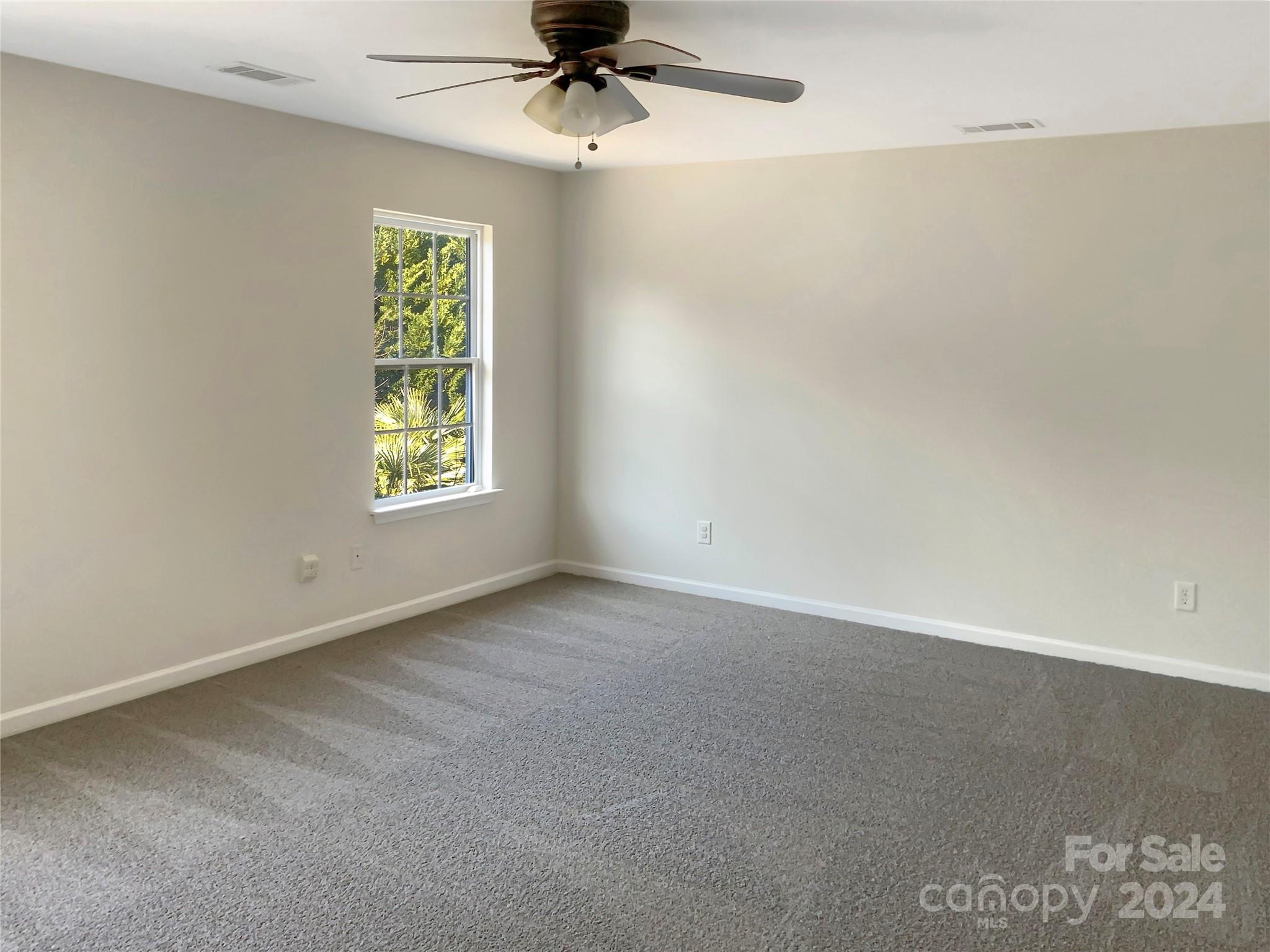13413 Meadowmere Road Huntersville, NC 28078 - Photo 20 of 22 an empty room with a window and a ceiling fan