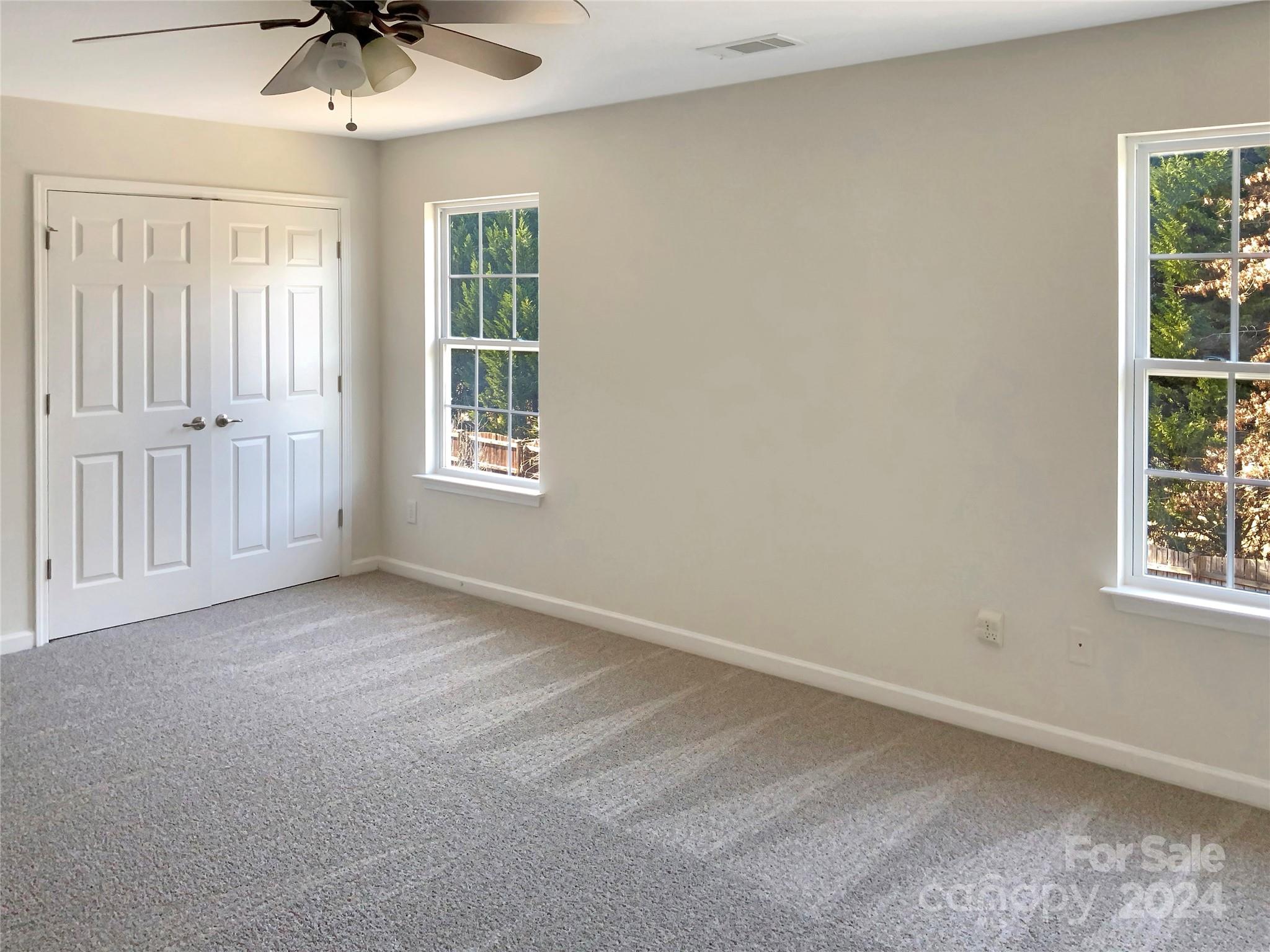 13413 Meadowmere Road Huntersville, NC 28078 - Photo 5 of 22 an empty room with a window and a ceiling fan