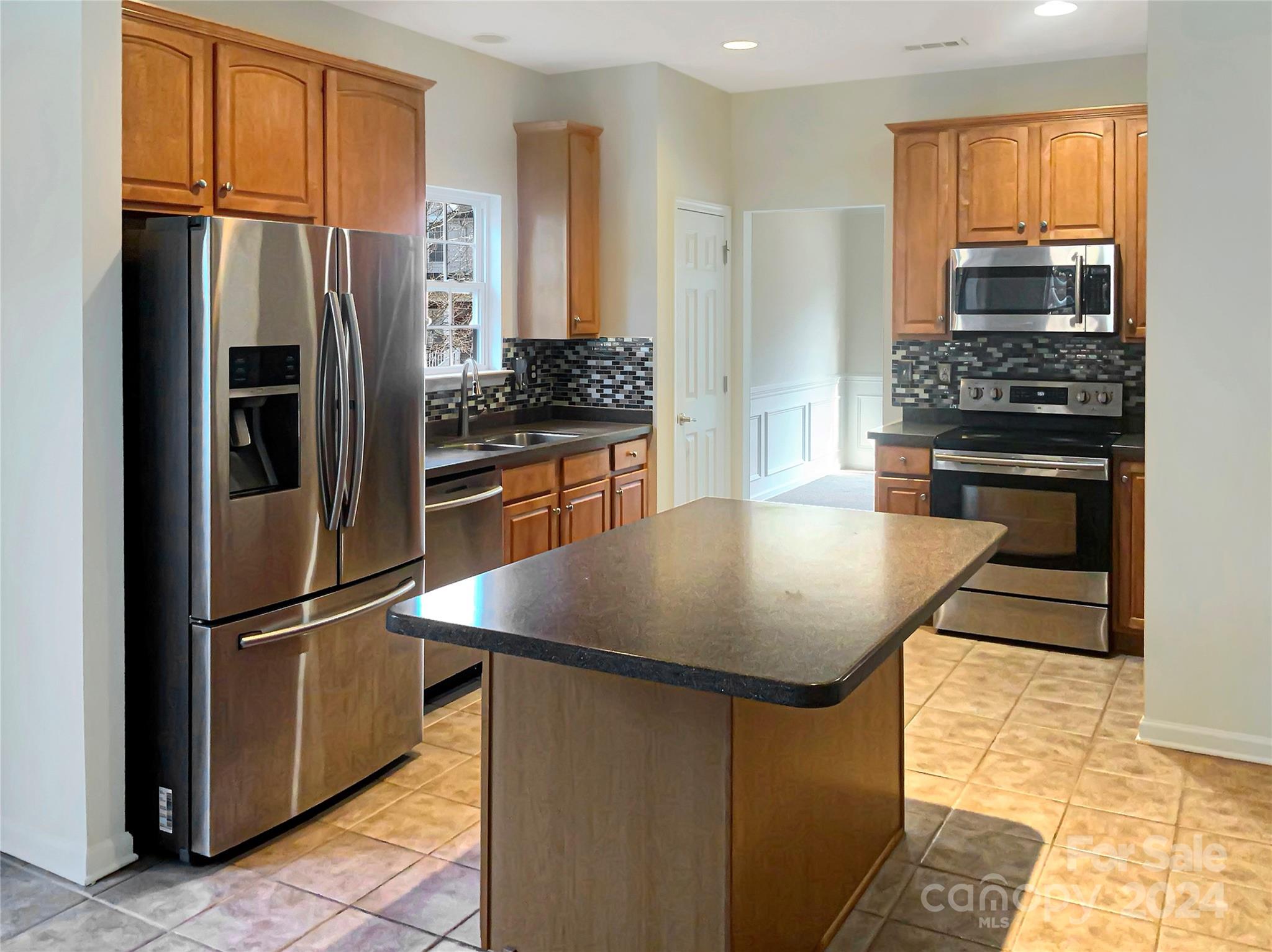 13413 Meadowmere Road Huntersville, NC 28078 - Photo 7 of 22 a kitchen with kitchen island granite countertop appliances cabinets and a counter space