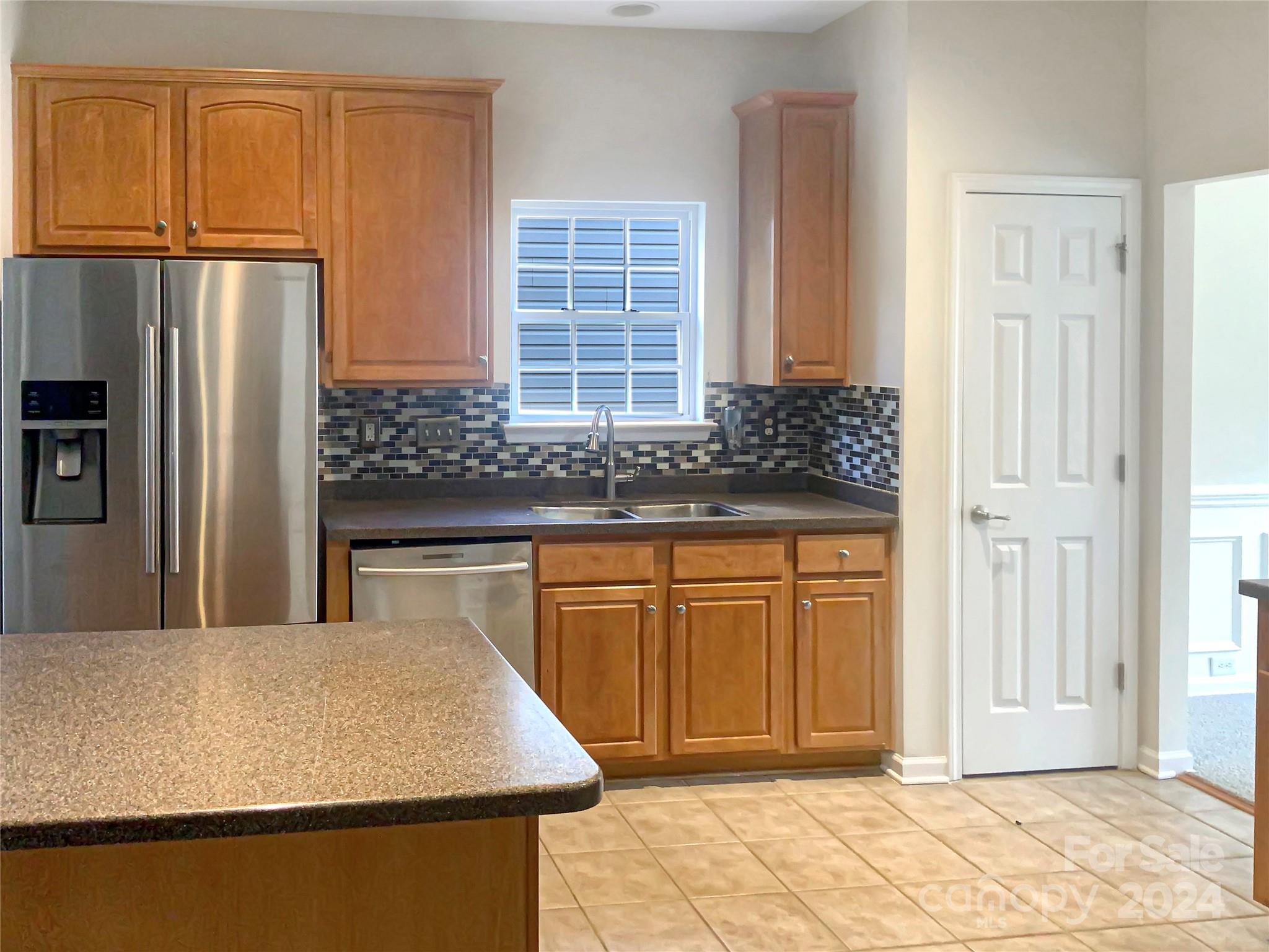 13413 Meadowmere Road Huntersville, NC 28078 - Photo 8 of 22 a kitchen with granite countertop a refrigerator and a sink