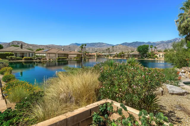 a view of a lake with houses in the back