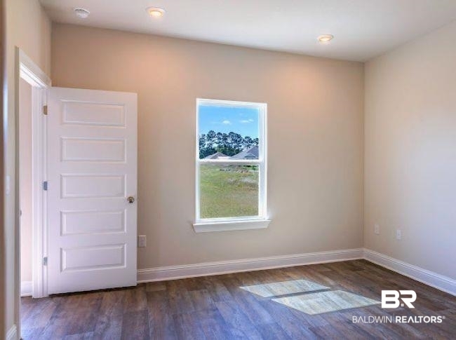 13791 Logan Place Foley, AL 36535 - Photo 14 of 25 Neutral toned walls with recessed lighting and wood-finish flooring