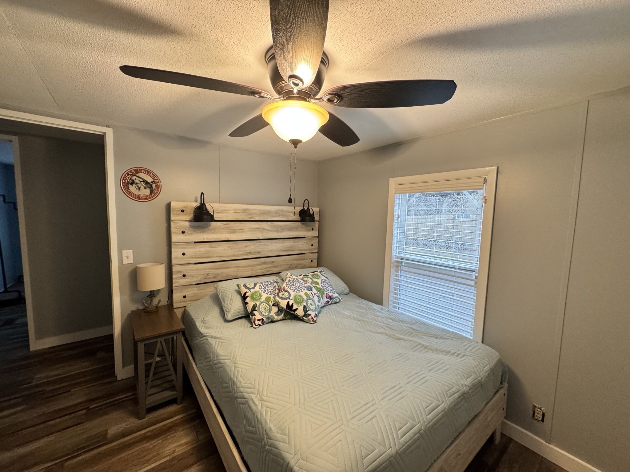 59 Riverview Lane Waverly, TN 37185 - Photo 13 of 28 a bedroom with a bed and a chandelier