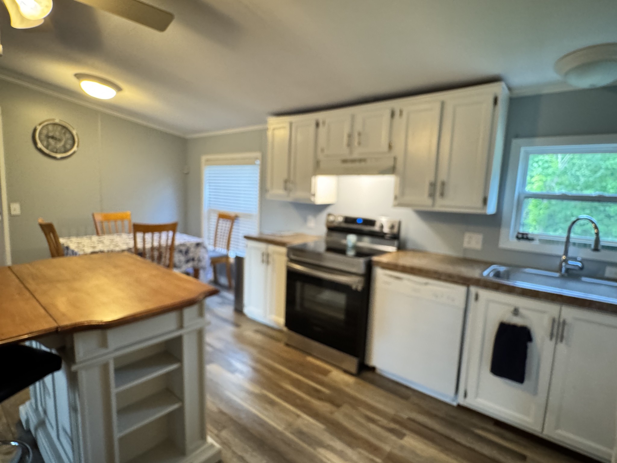 59 Riverview Lane Waverly, TN 37185 - Photo 6 of 28 a kitchen with a stove a sink and a microwave