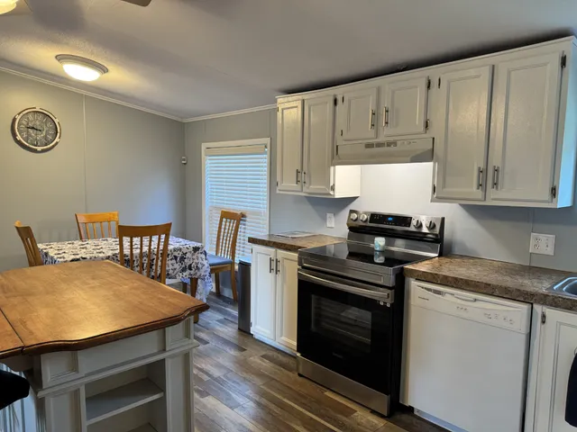 a kitchen with stainless steel appliances a stove a sink dishwasher and cabinets