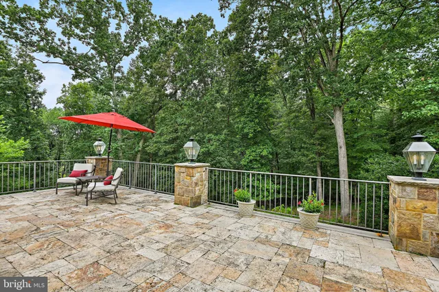 a living room with furniture a chandelier and wooden floor