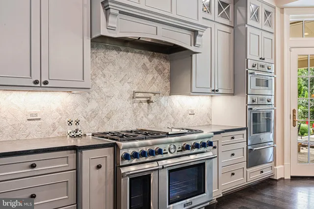 a living room with furniture a fireplace and a chandelier