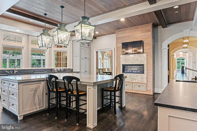 a view of a dining room with furniture a fireplace and chandelier