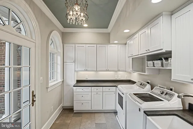 a front view of a house with a yard and potted plants