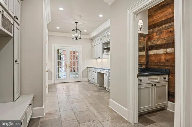 a view of a house with a yard and potted plants