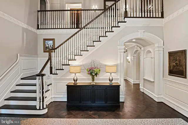 a living room with furniture chandelier and a fireplace