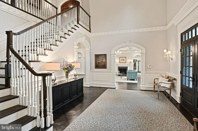 a living room with furniture a fireplace and a large window