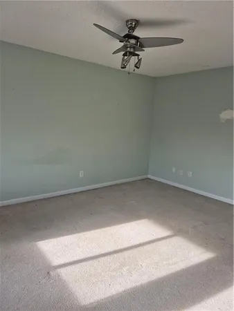 a view of an empty room and a window