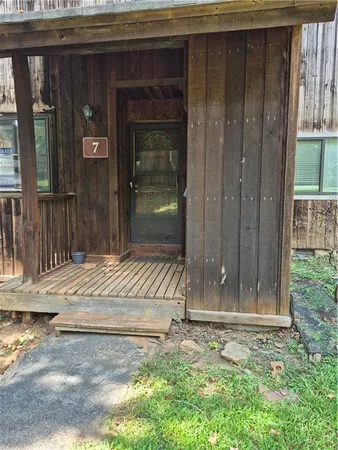 a view of a house with a wooden fence