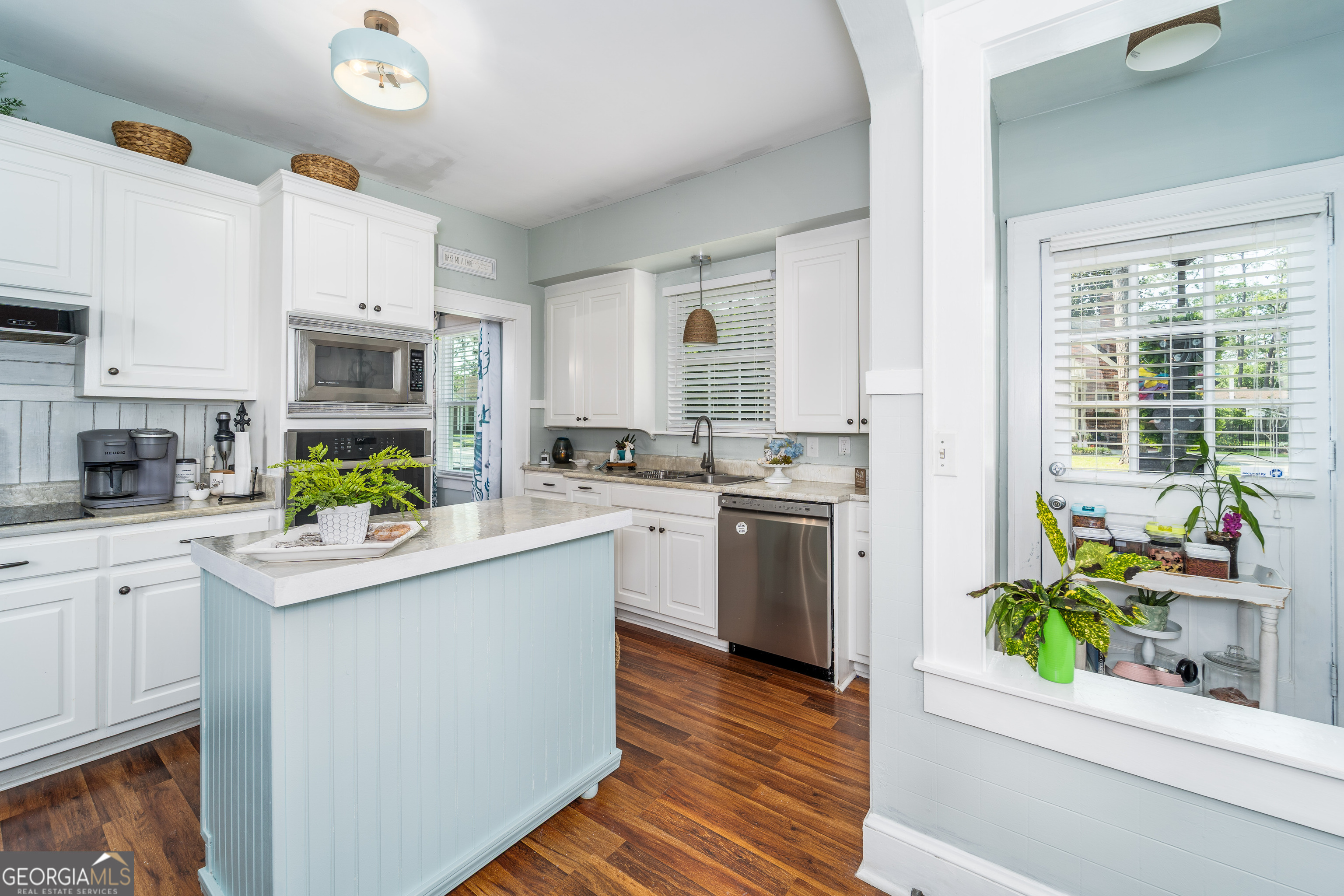 1101 Cherokee Drive Waycross, GA 31501 - Photo 15 of 24 a kitchen with white cabinets and white appliances