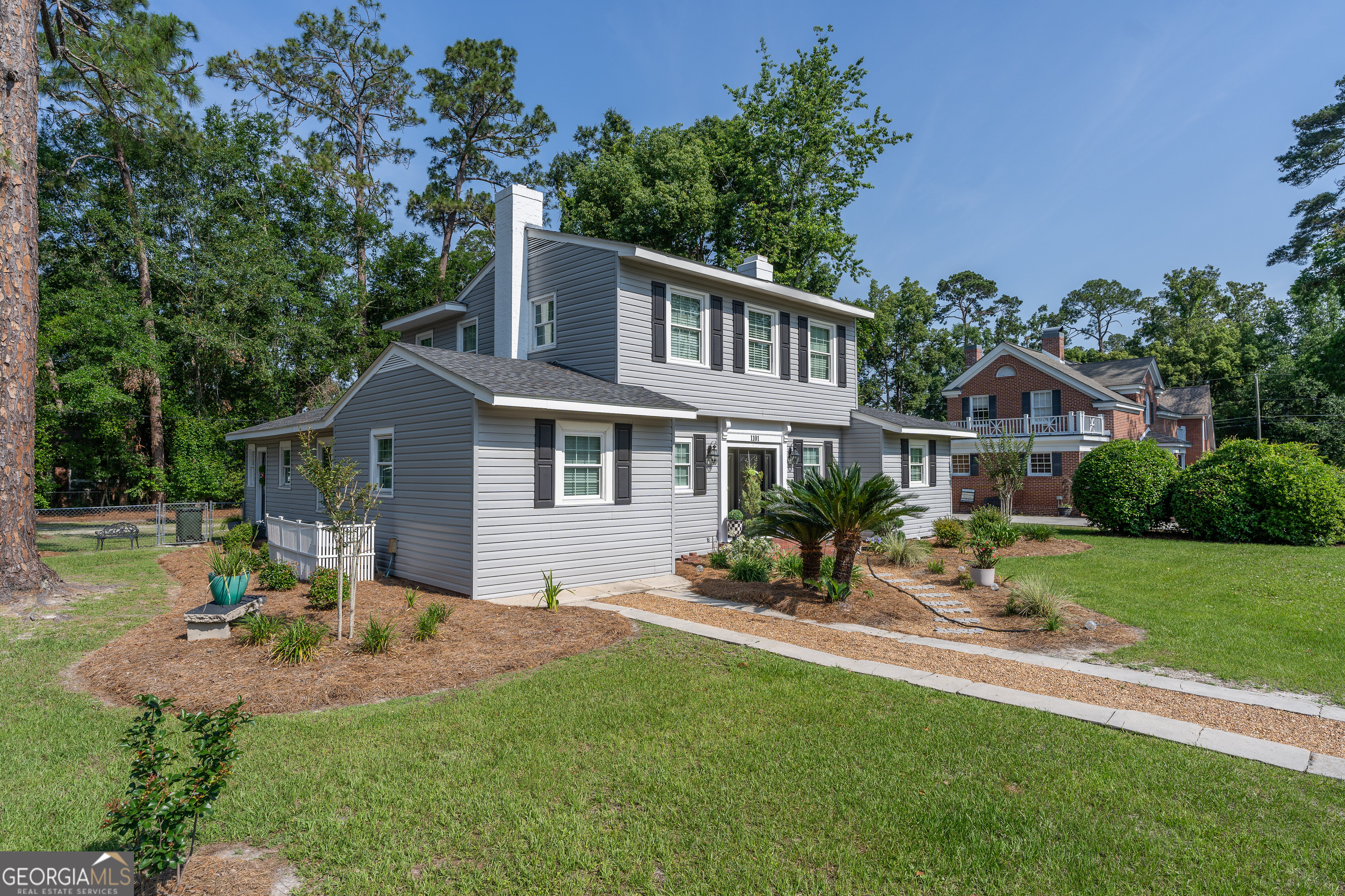 1101 Cherokee Drive Waycross, GA 31501 - Photo 5 of 24 a front view of a house with a yard table and chairs