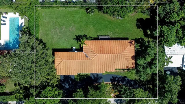 an aerial view of a houses with a yard